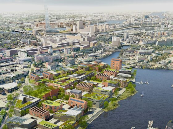 Luftaufnahme einer städtischen Gegend mit Gebäuden entlang eines Flusses.